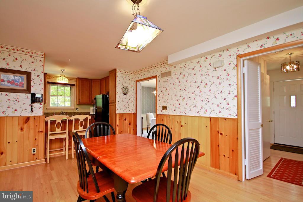 8200 Burnley Road Baltimore, MD 21204 - Photo 8 of 21 a dining room with furniture a chandelier and wooden floor