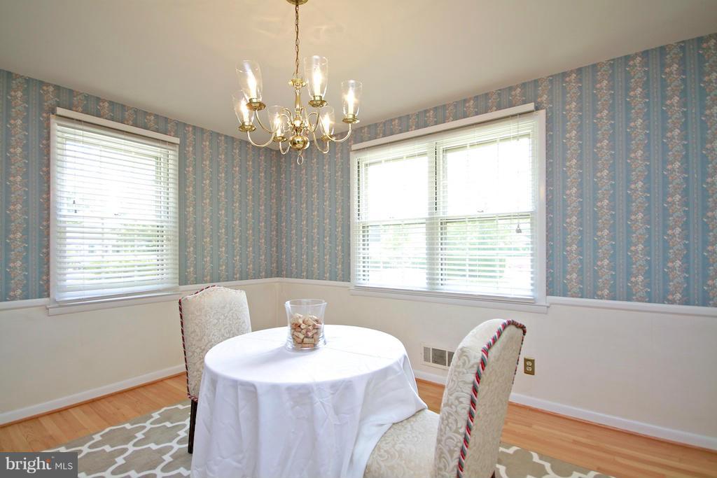 8200 Burnley Road Baltimore, MD 21204 - Photo 10 of 21 a dining room with wooden floor and chandelier