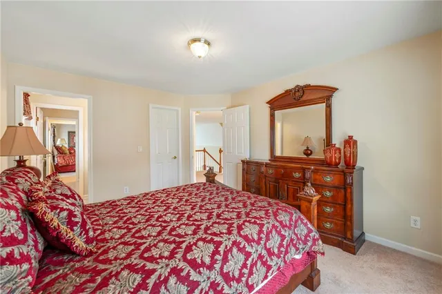 a bedroom with a bed and a dresser in it