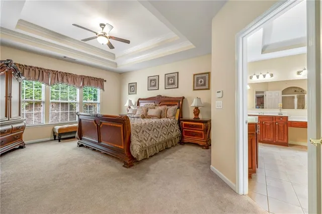 a spacious bedroom with a bed and a chandelier