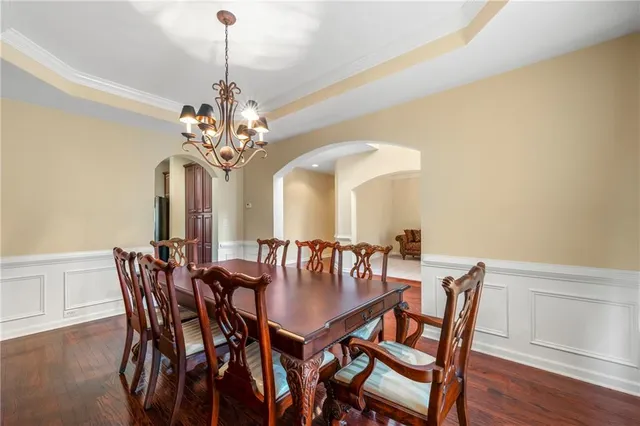 a view of a dining room with furniture and chandelier