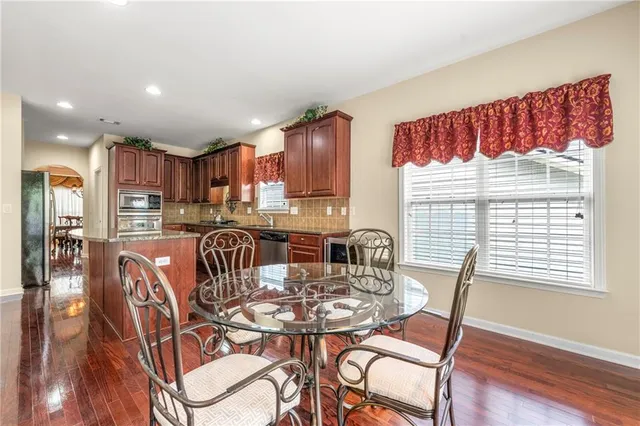 a view of a dining room with furniture window and wooden floor
