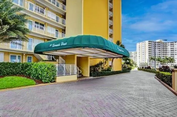 a view of a building with a yard