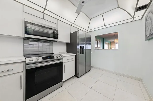 a kitchen with stainless steel appliances granite countertop a stove and a refrigerator