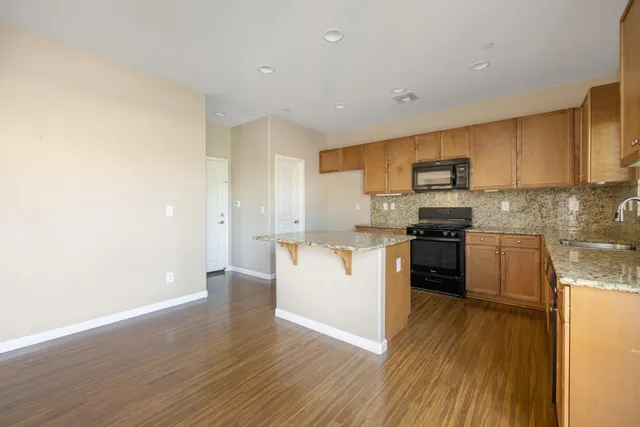 a kitchen with wooden floors and white appliances