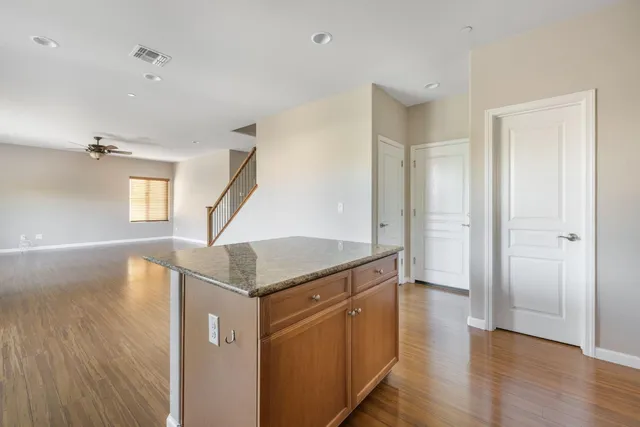 a view of a kitchen with furniture and wooden floor