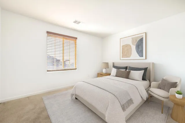 a bedroom with a bed and a window