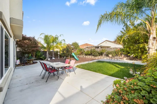 a view of a patio with a table and chairs