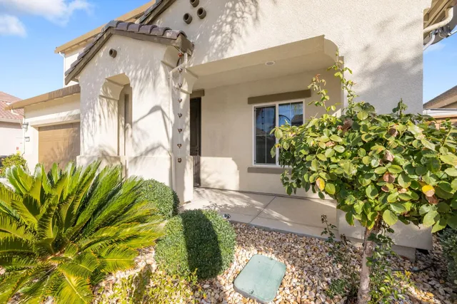 a front view of a house with garden