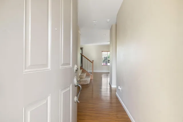 a view of entryway and hall with wooden floor