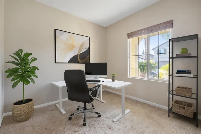 a work room with furniture and a potted plant
