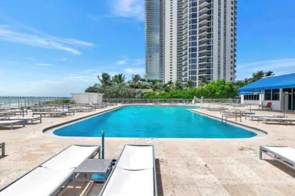 a view of a swimming pool with a lounge chairs