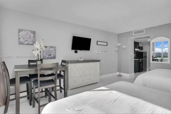 a bedroom with a bed and a flat screen tv