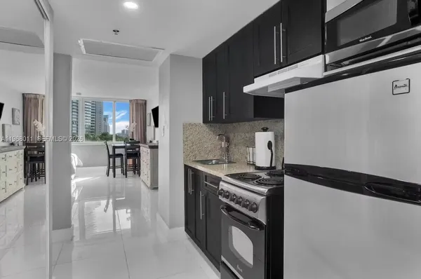 a kitchen with stainless steel appliances granite countertop a stove and a refrigerator