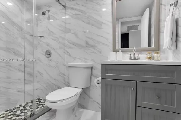 a bathroom with a sink toilet and shower