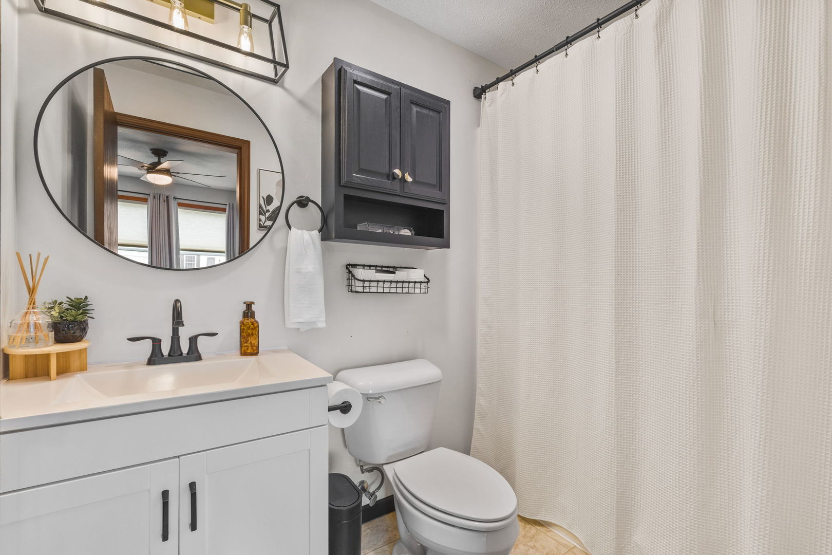 1005 17th Avenue Silvis, IL 61282 - Photo 16 of 34 a bathroom with a toilet a sink and a mirror
