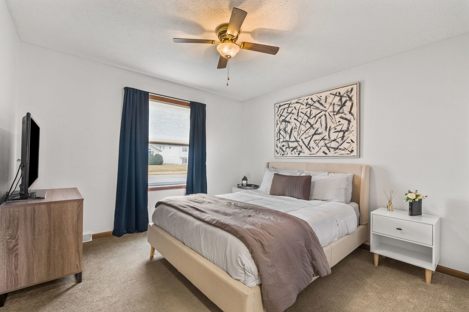 1005 17th Avenue Silvis, IL 61282 - Photo 17 of 34 a spacious bedroom with a bed and a flat screen tv