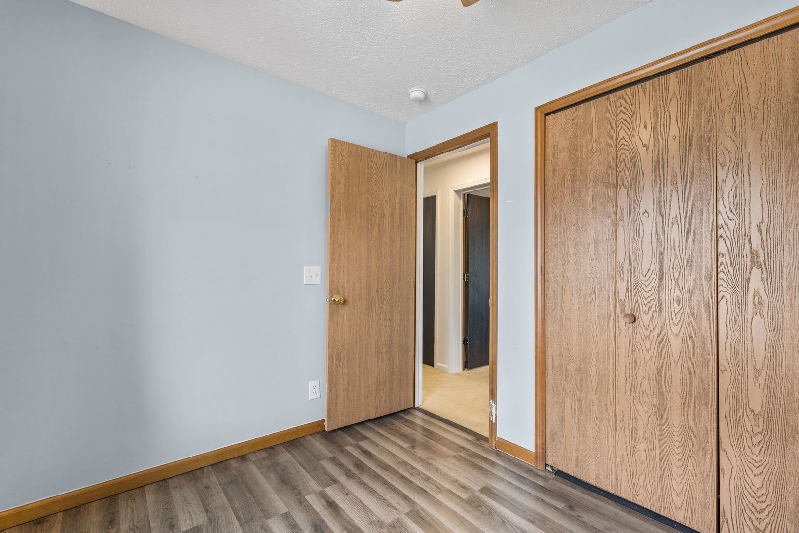 1005 17th Avenue Silvis, IL 61282 - Photo 21 of 34 a view of hallway with closet and wooden floor