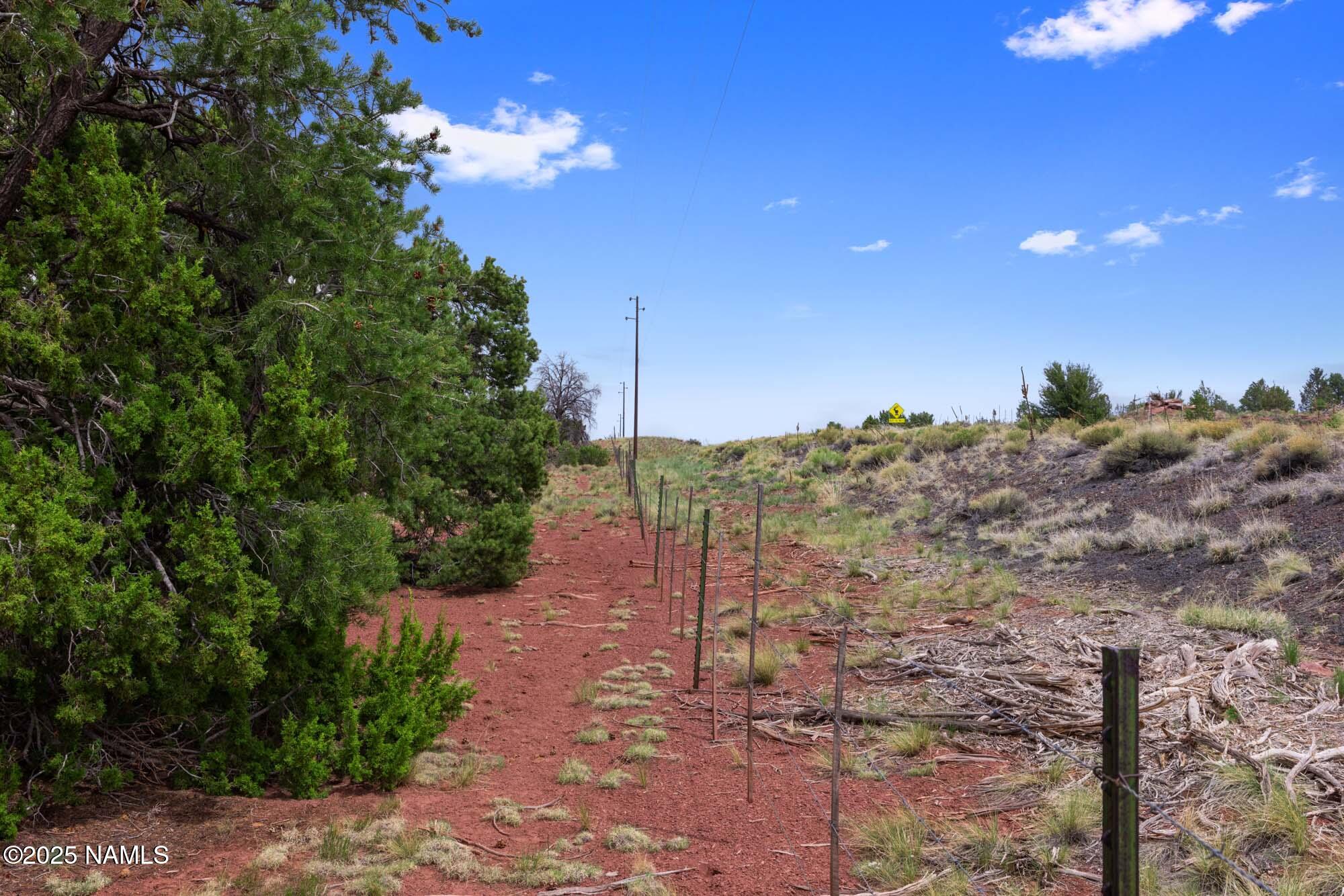 8449 Water Tank Circle, Unit A Williams, AZ 86046 - Photo 25 of 56 a view of a dry yard with lots of green space