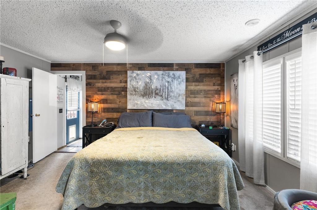 224 Hebron Road Commerce, GA 30530 - Photo 12 of 25 a bed sitting in a spacious bedroom next to a window