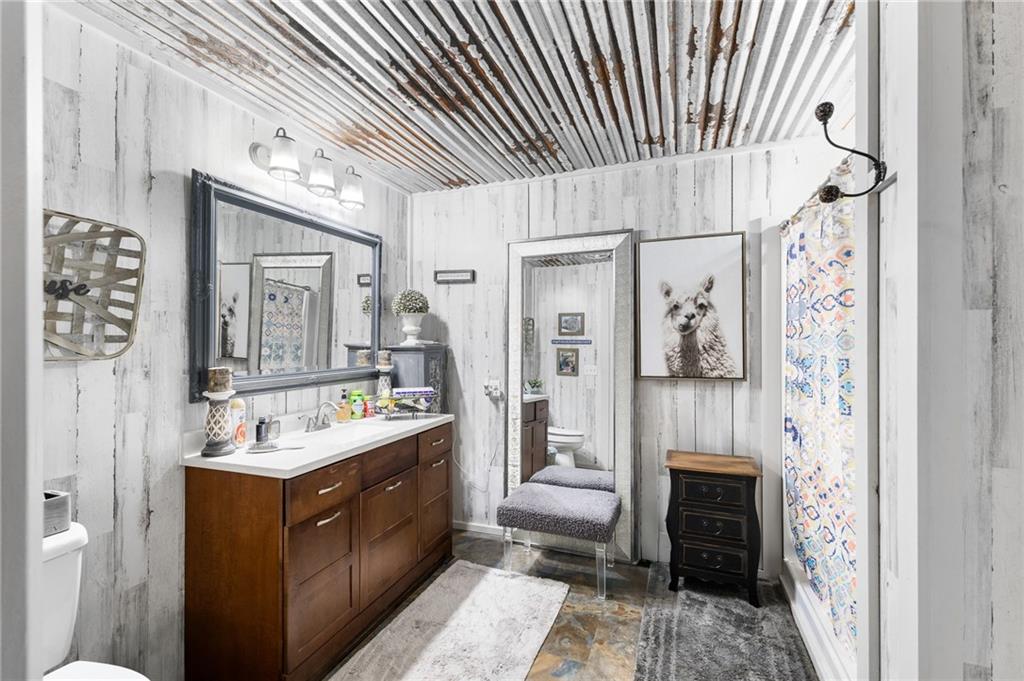 224 Hebron Road Commerce, GA 30530 - Photo 13 of 25 a bathroom with a sink a mirror and a shower