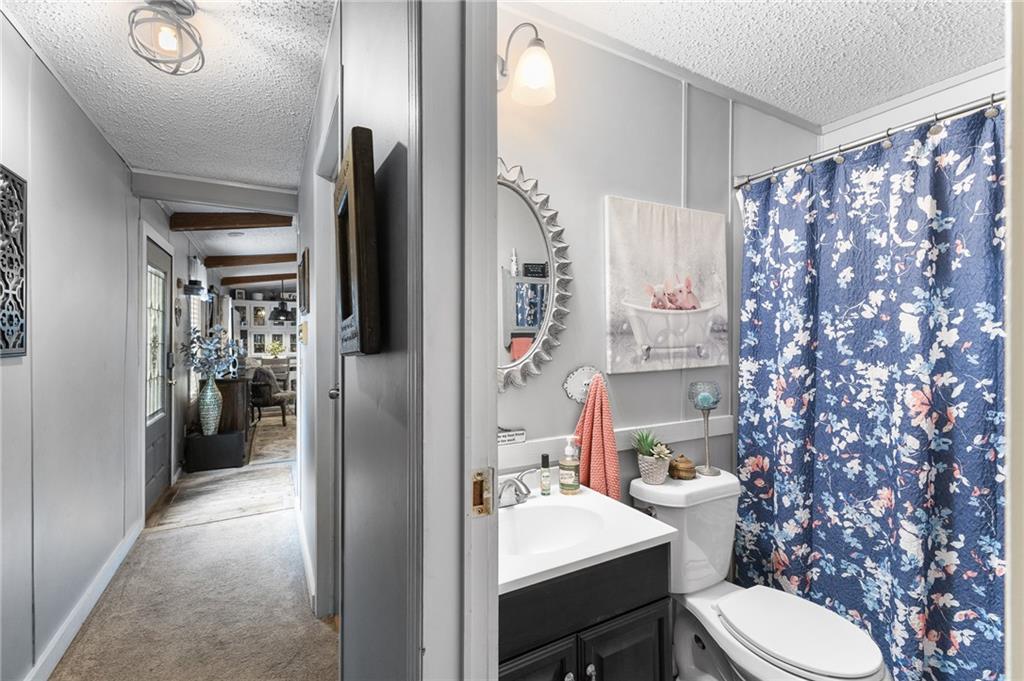 224 Hebron Road Commerce, GA 30530 - Photo 15 of 25 a bathroom with a sink toilet and shower