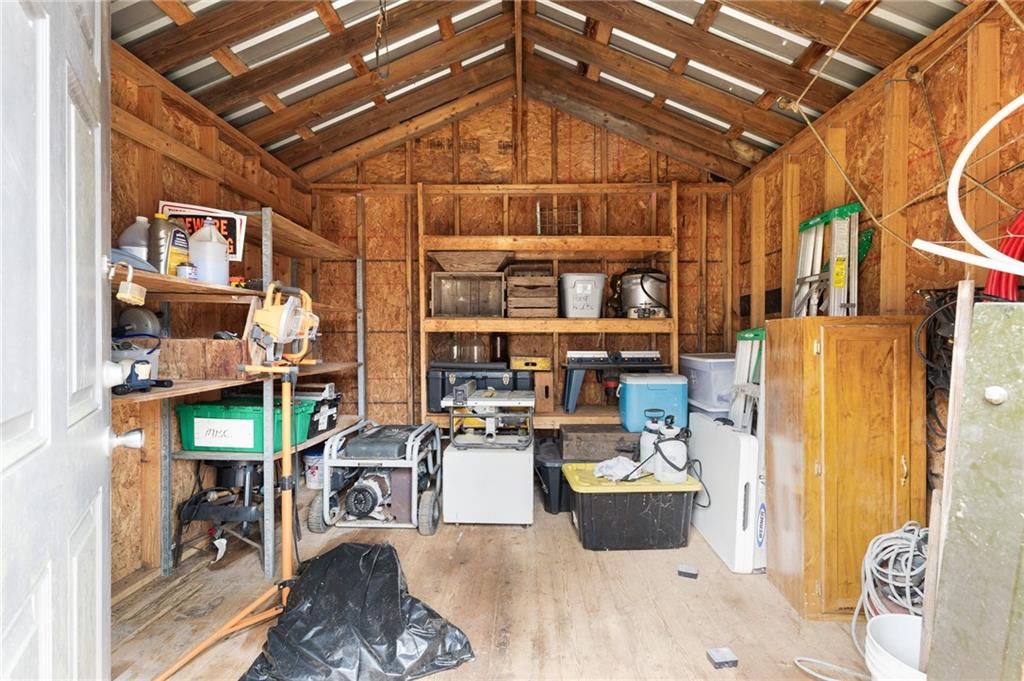 224 Hebron Road Commerce, GA 30530 - Photo 18 of 25 a living room with lots of furniture and a chandelier