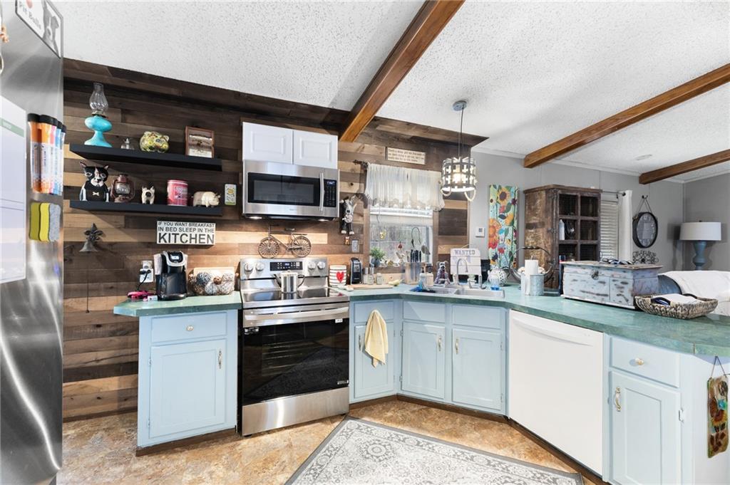 224 Hebron Road Commerce, GA 30530 - Photo 9 of 25 a kitchen with stainless steel appliances granite countertop a stove and cabinets