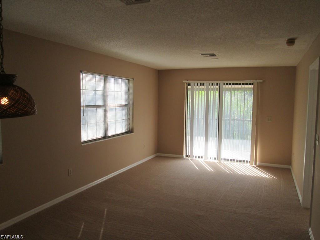 5355 Treetops Drive, Unit S201 Naples, FL 34113 - Photo 7 of 7 an empty room with windows