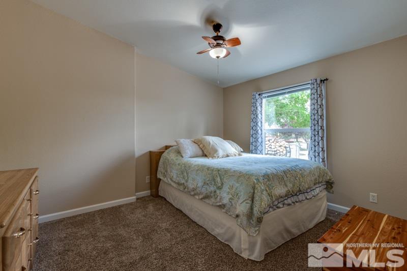 4989 Cody Road Fallon, NV 89406 - Photo 17 of 39 a bed sitting in a bedroom next to a window