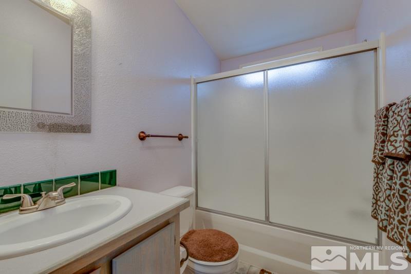 4989 Cody Road Fallon, NV 89406 - Photo 20 of 39 a bathroom with a granite countertop sink and a mirror