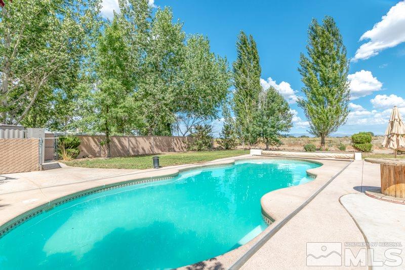 4989 Cody Road Fallon, NV 89406 - Photo 25 of 39 a view of a swimming pool with a yard