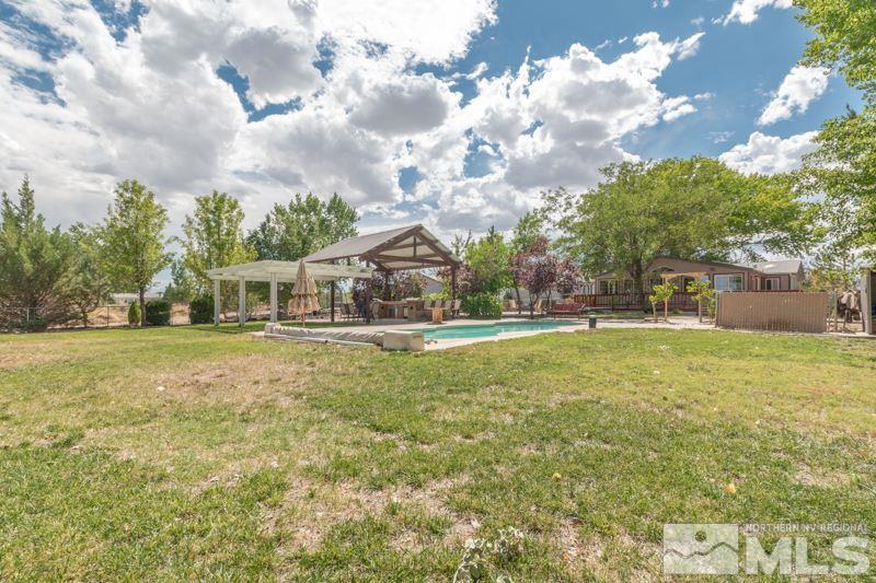 4989 Cody Road Fallon, NV 89406 - Photo 29 of 39 a house view with swimming pool and trees in the background
