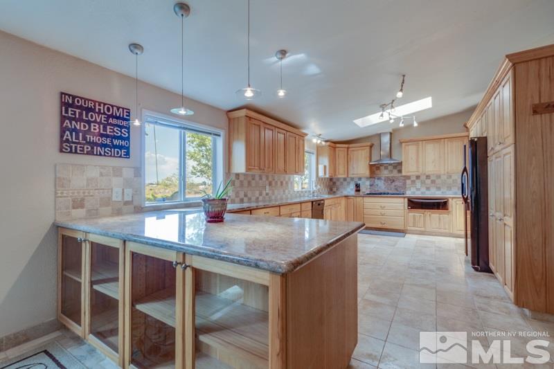 4989 Cody Road Fallon, NV 89406 - Photo 7 of 39 a kitchen with stainless steel appliances granite countertop a sink a oven a kitchen island with wooden cabinets and floor