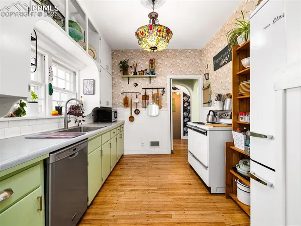 a kitchen with cabinets a sink and appliances
