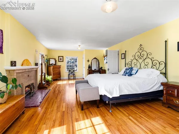 a spacious bedroom with a bed and a table in it