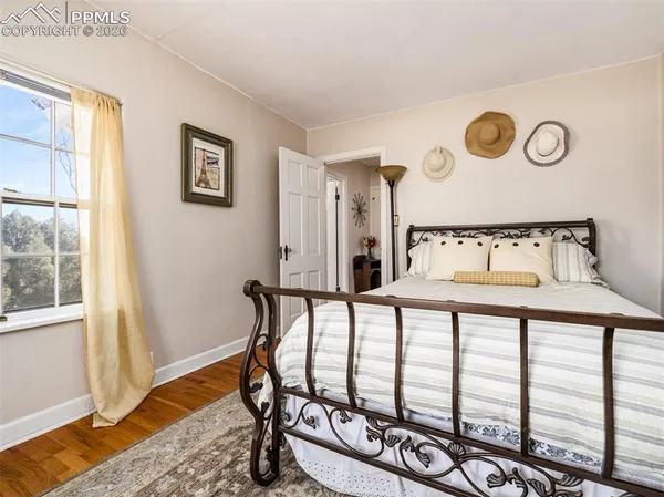 a view of a room with furniture and wooden floor