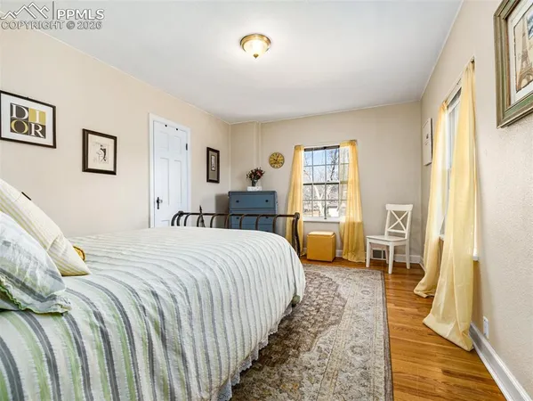 a bedroom with a large bed couch and a window
