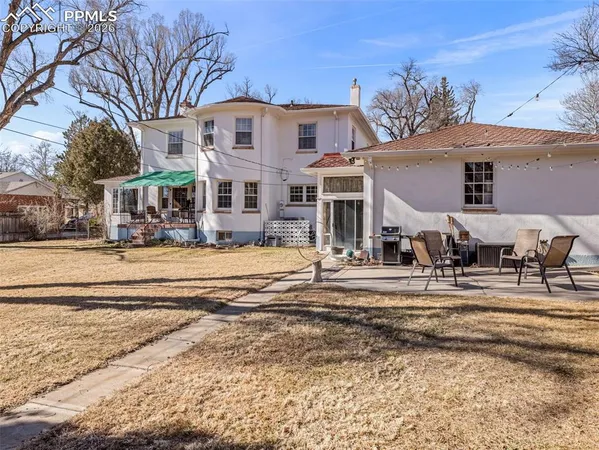 a front view of a building with a yard