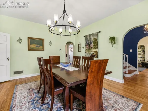 a view of a dining room with furniture wooden floor and chandelier
