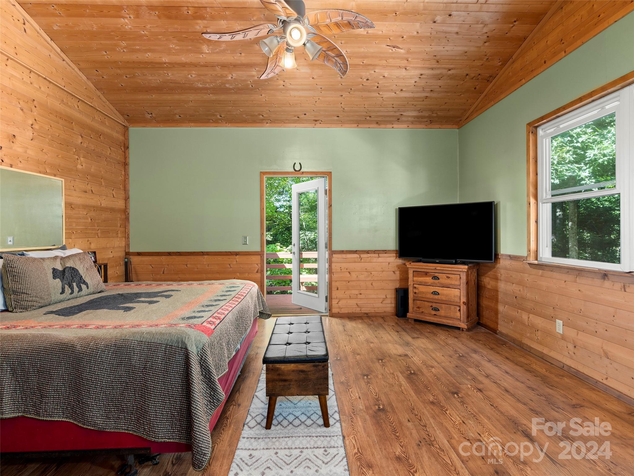 25 Dawn Valley Road Waynesville, NC 28785 - Photo 15 of 46 a bedroom with a bed and a flat screen tv