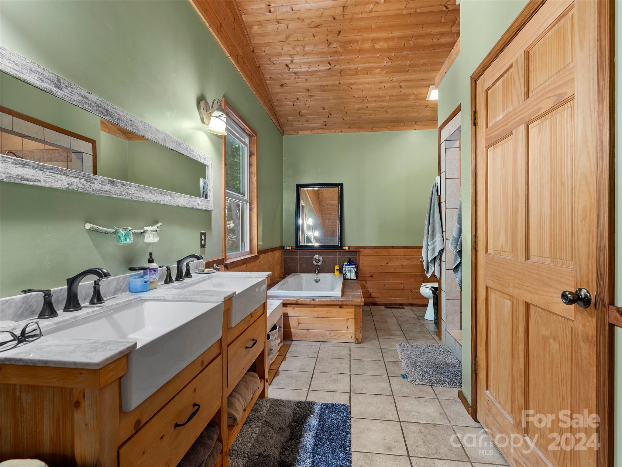 25 Dawn Valley Road Waynesville, NC 28785 - Photo 17 of 46 a spacious bathroom with a double vanity sink a mirror and a shower