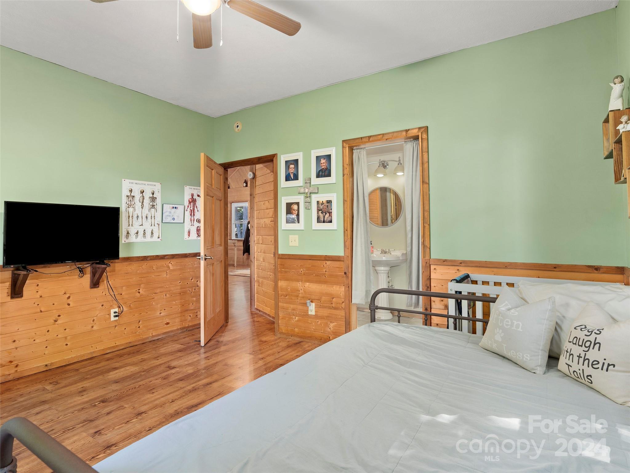 25 Dawn Valley Road Waynesville, NC 28785 - Photo 20 of 46 a bedroom with furniture and a flat screen tv