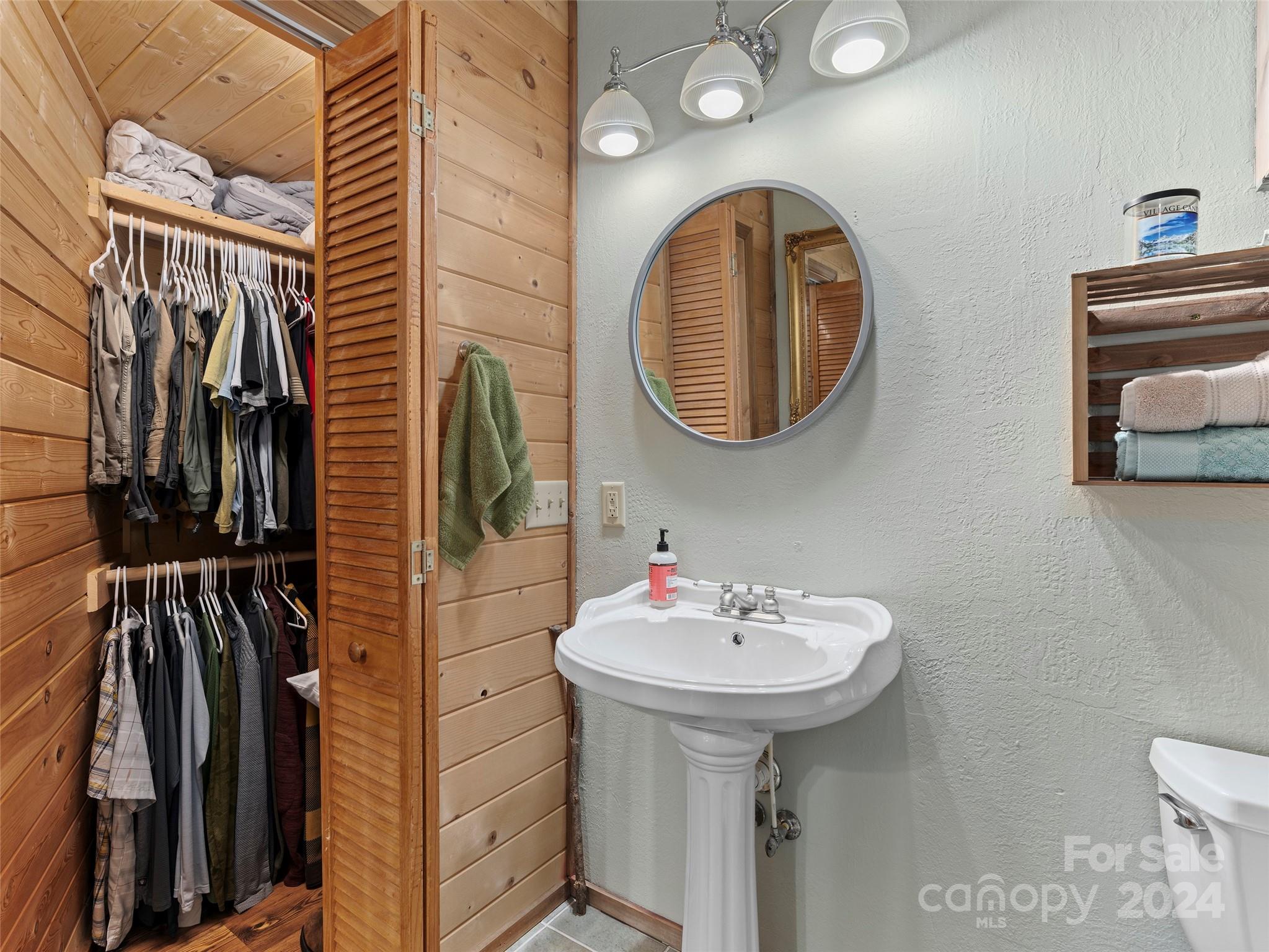 25 Dawn Valley Road Waynesville, NC 28785 - Photo 21 of 46 a bathroom with a sink and a mirror