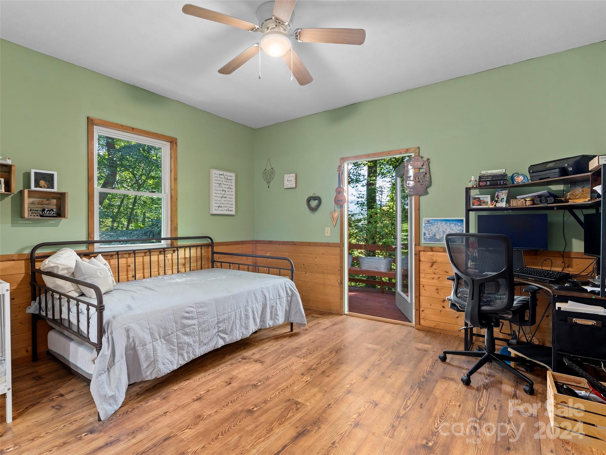 25 Dawn Valley Road Waynesville, NC 28785 - Photo 23 of 46 a bedroom with a bed wooden floor and a window