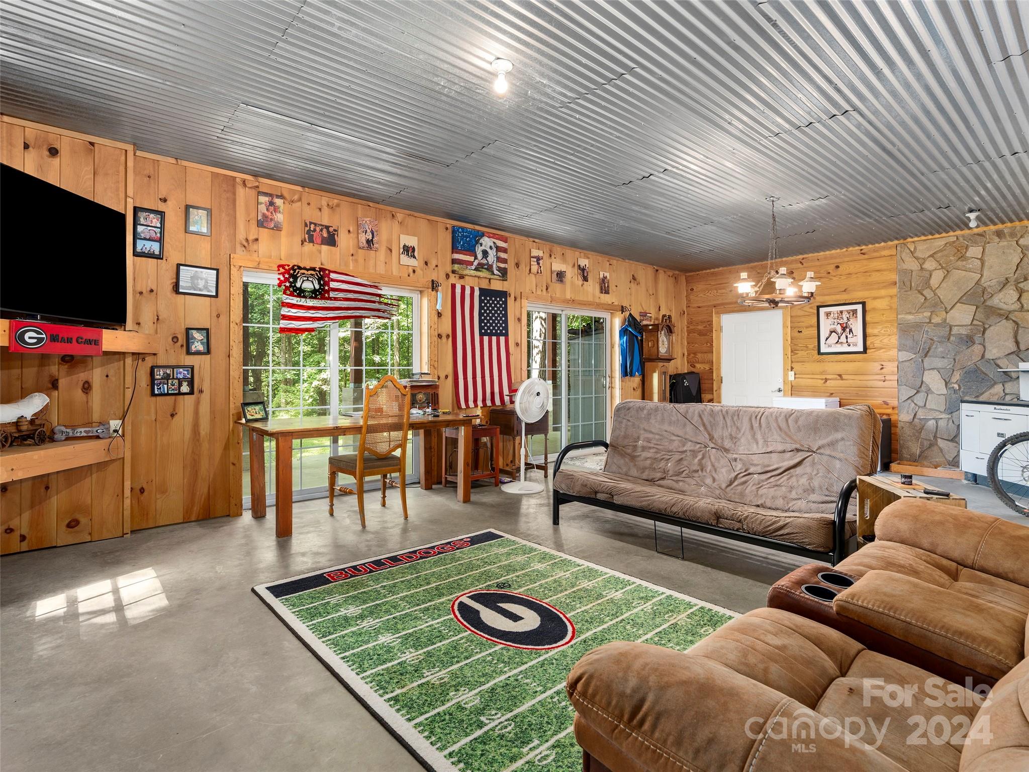 25 Dawn Valley Road Waynesville, NC 28785 - Photo 29 of 46 a living room with furniture a flat screen tv and a refrigerator