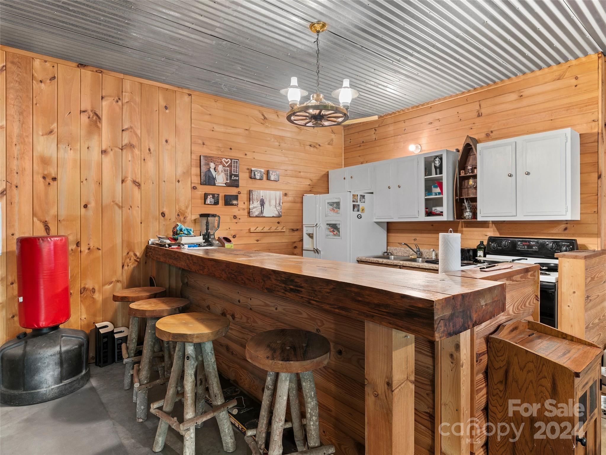 25 Dawn Valley Road Waynesville, NC 28785 - Photo 30 of 46 a kitchen with a table chairs stove and cabinets