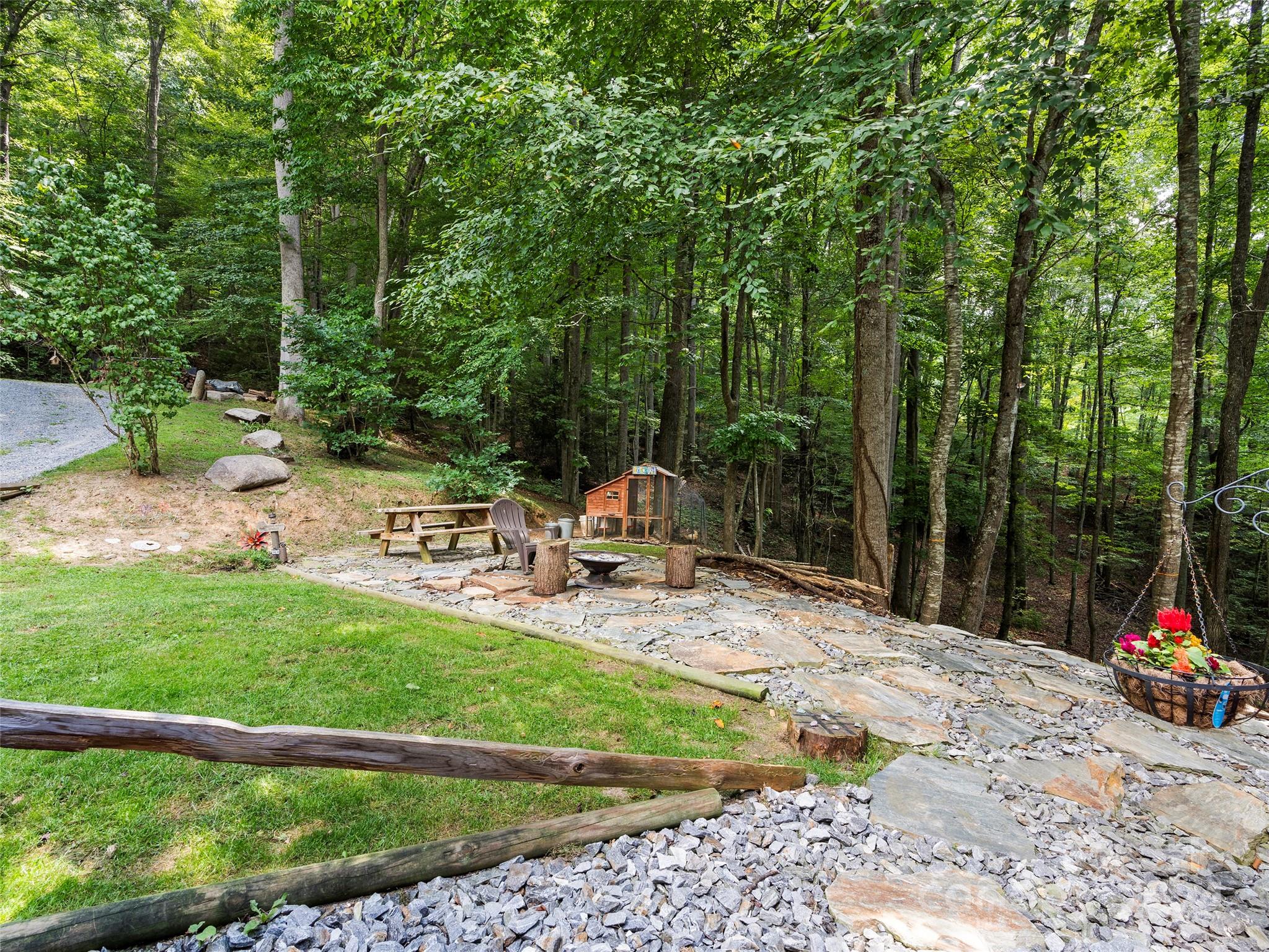 25 Dawn Valley Road Waynesville, NC 28785 - Photo 39 of 46 a view of a chair and tables in the backyard