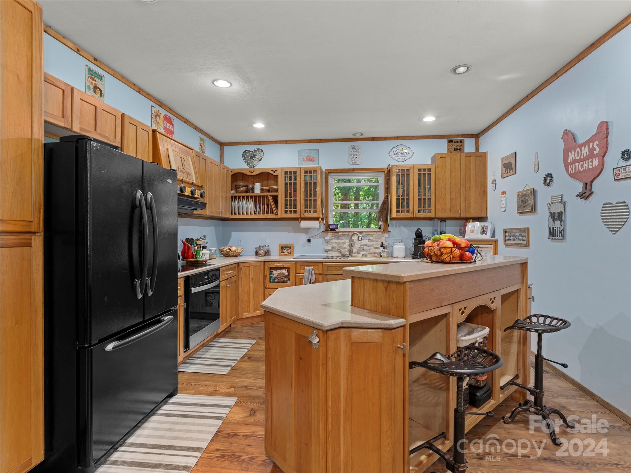 25 Dawn Valley Road Waynesville, NC 28785 - Photo 7 of 46 a kitchen with stainless steel appliances granite countertop a refrigerator and a stove top oven