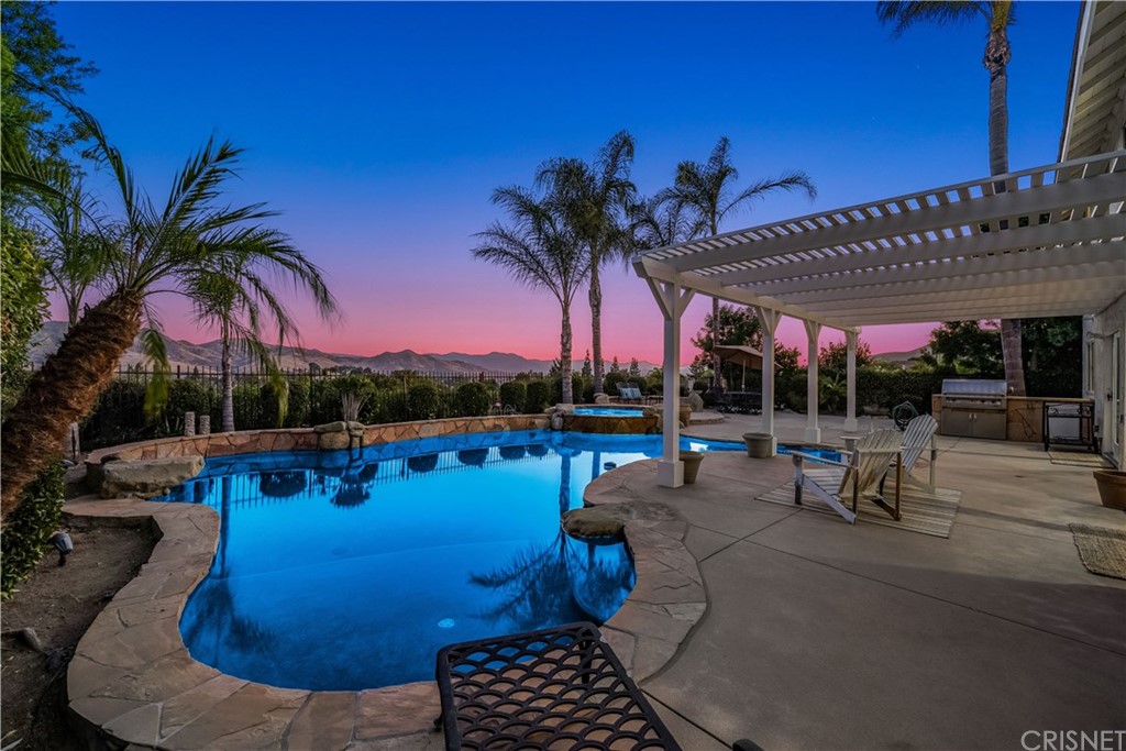 a view of a swimming pool with sitting area